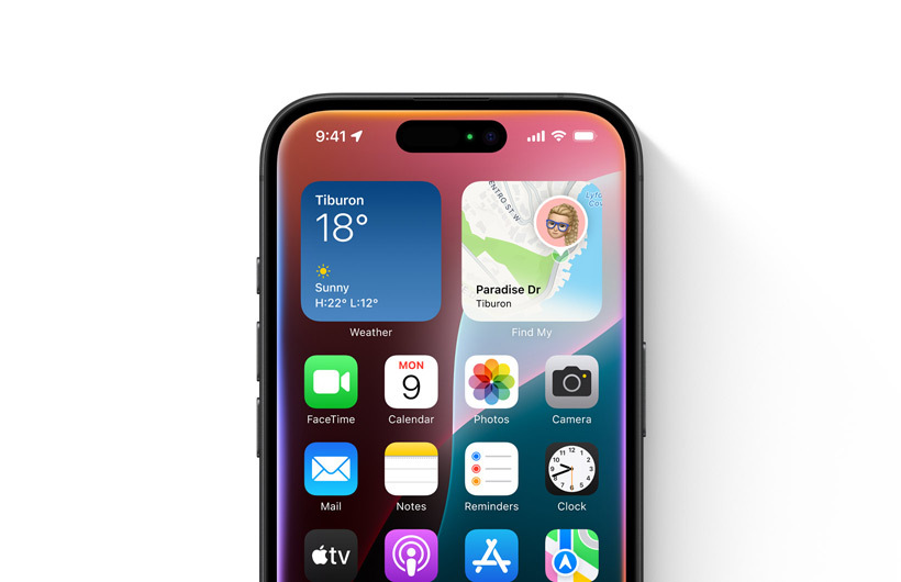 Une légère lueur colorée est à peine visible sur le contour de l’écran d’un iPhone affichant l’écran d’accueil.