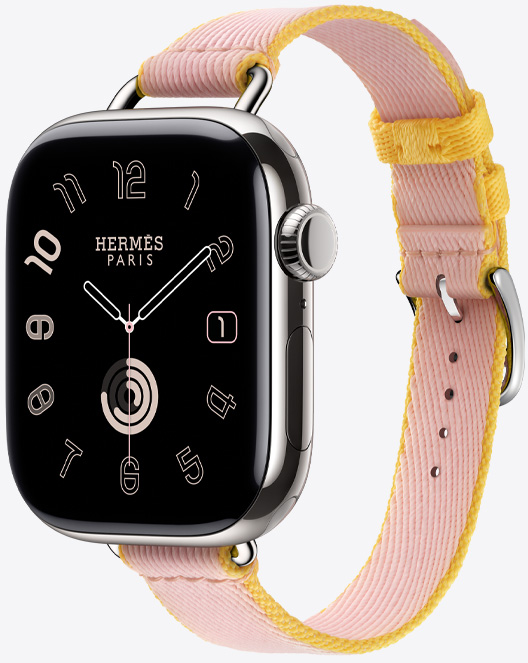 Il cinturino Simple Tour Attelage Twill Jump color Rose Sakura/Jaune de Naples (rosa/giallo) visto di lato con il quadrante Hermès Radial.