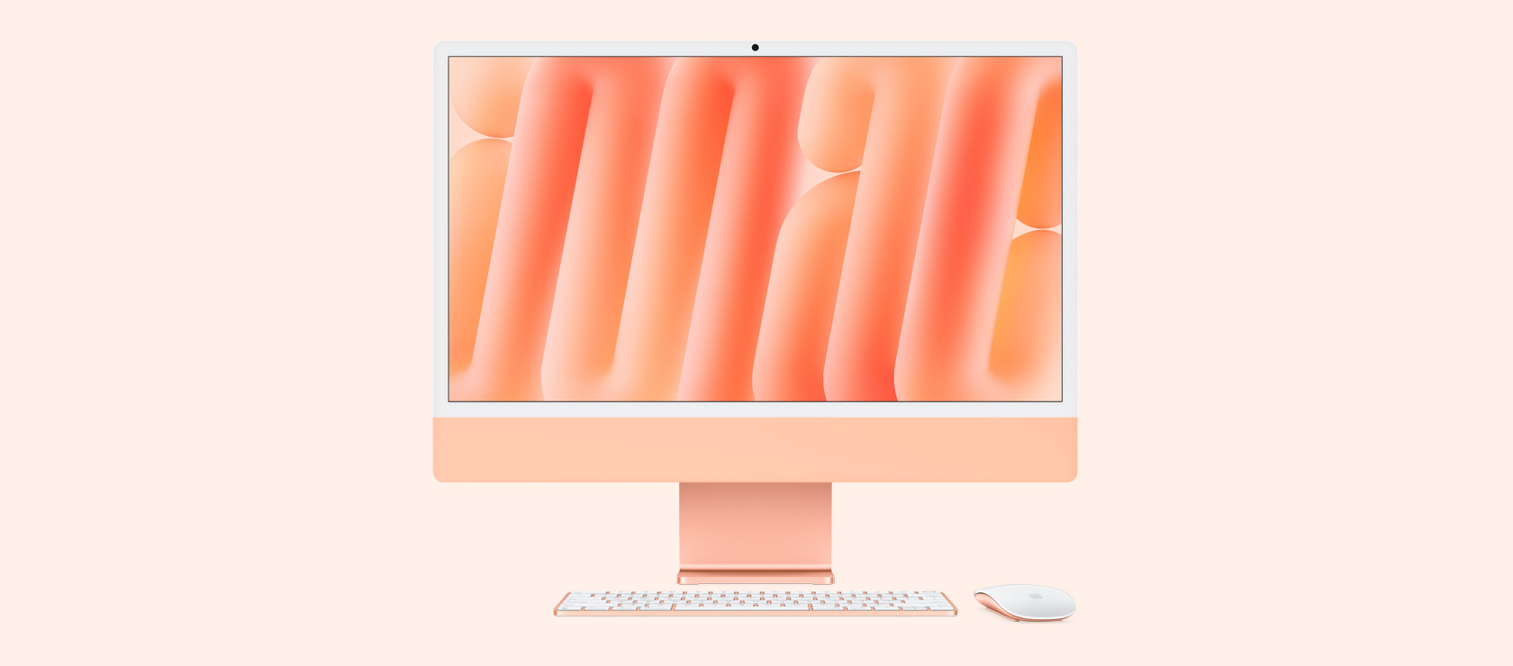Vista frontal de una iMac naranja con mouse y teclado a juego