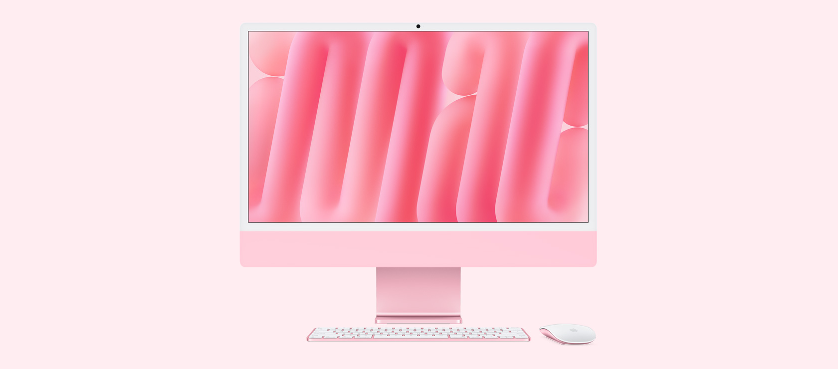 Vista frontal de una iMac rosa con mouse y teclado a juego