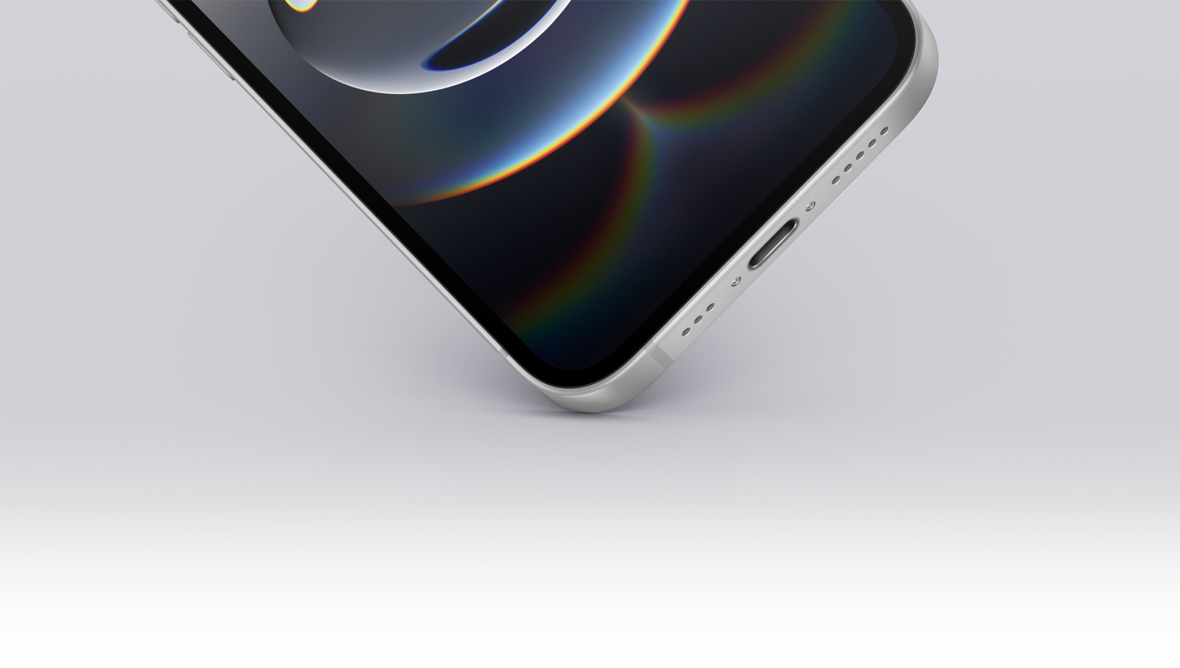 Un iPhone 16e che tocca terra con l’angolo inferiore; si nota la porta USB-C.
